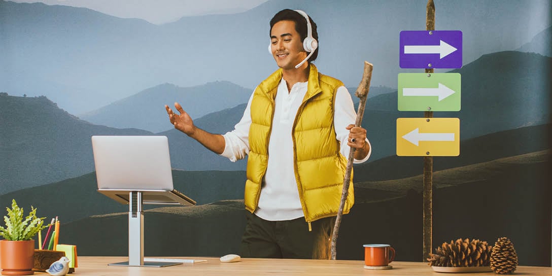Man with headset and laptop stands by directional signs, representing data-driven decisions in call center analytics.