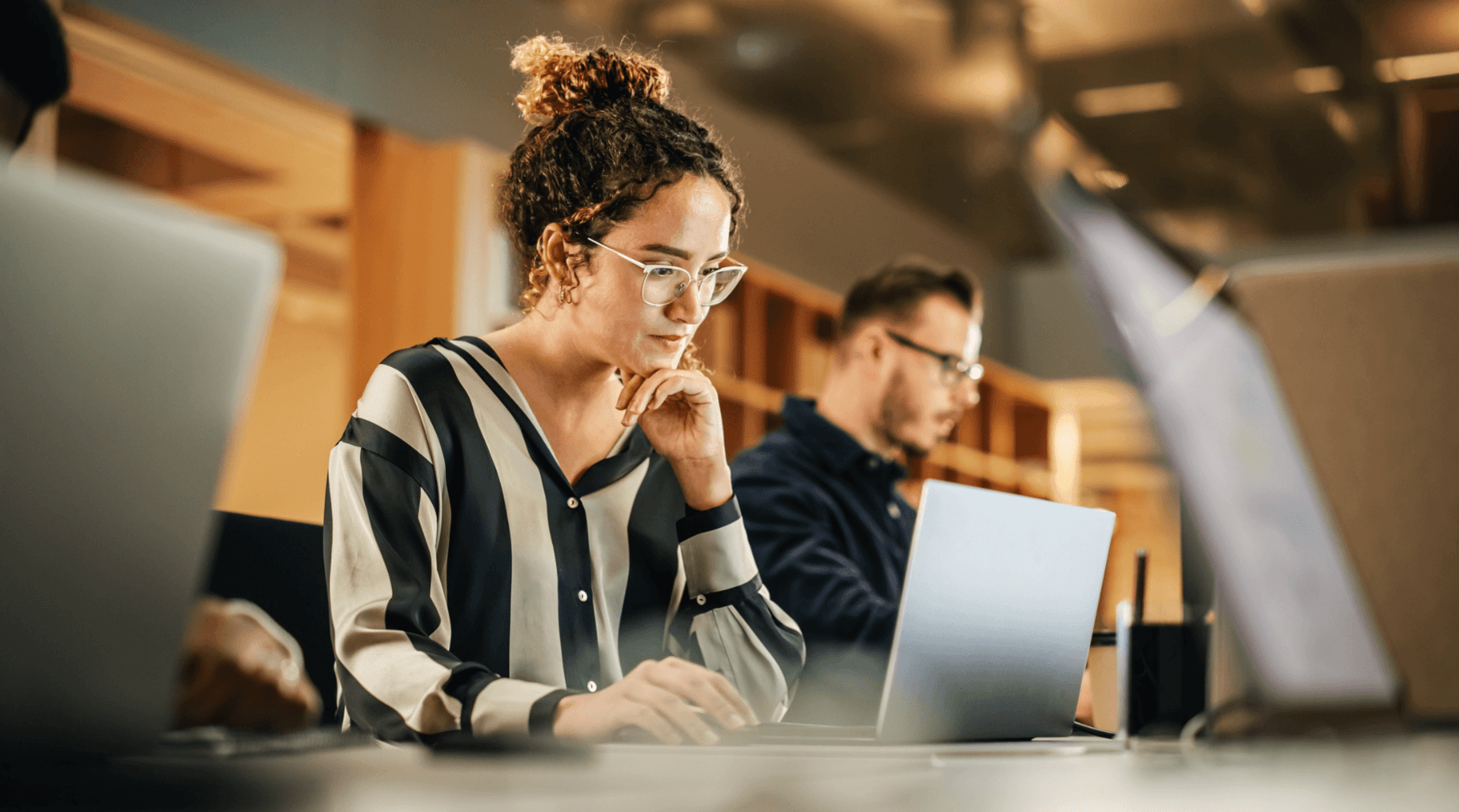 Professional customer service team working on laptops, representing AI chatbot use cases in modern customer service operations.