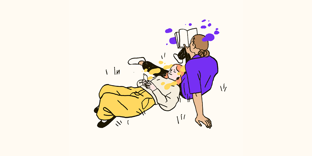 Two individuals in the grass using a generative AI glossary to understand AI.