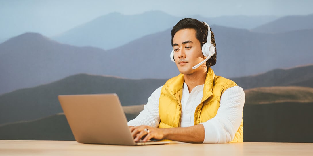 A sales rep sitting at a desk performing tech sales.