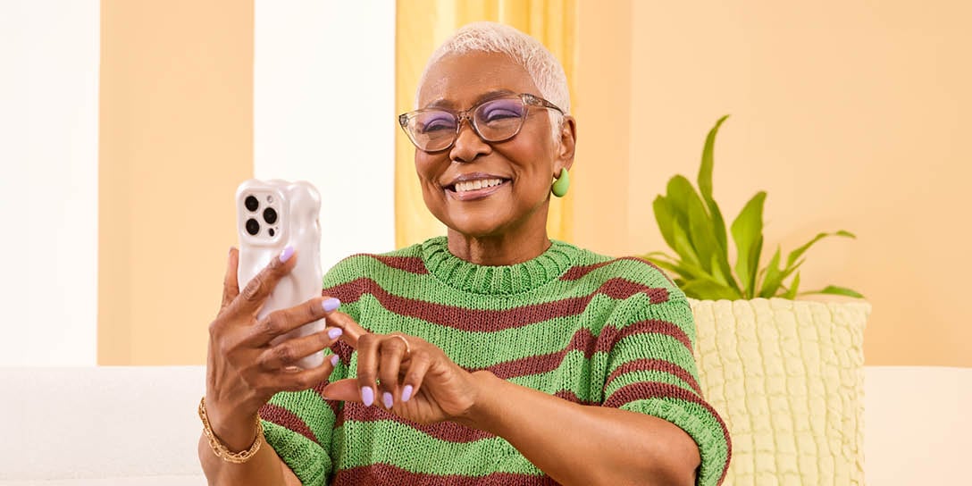 A happy customer uses an IVR system on their mobile device.