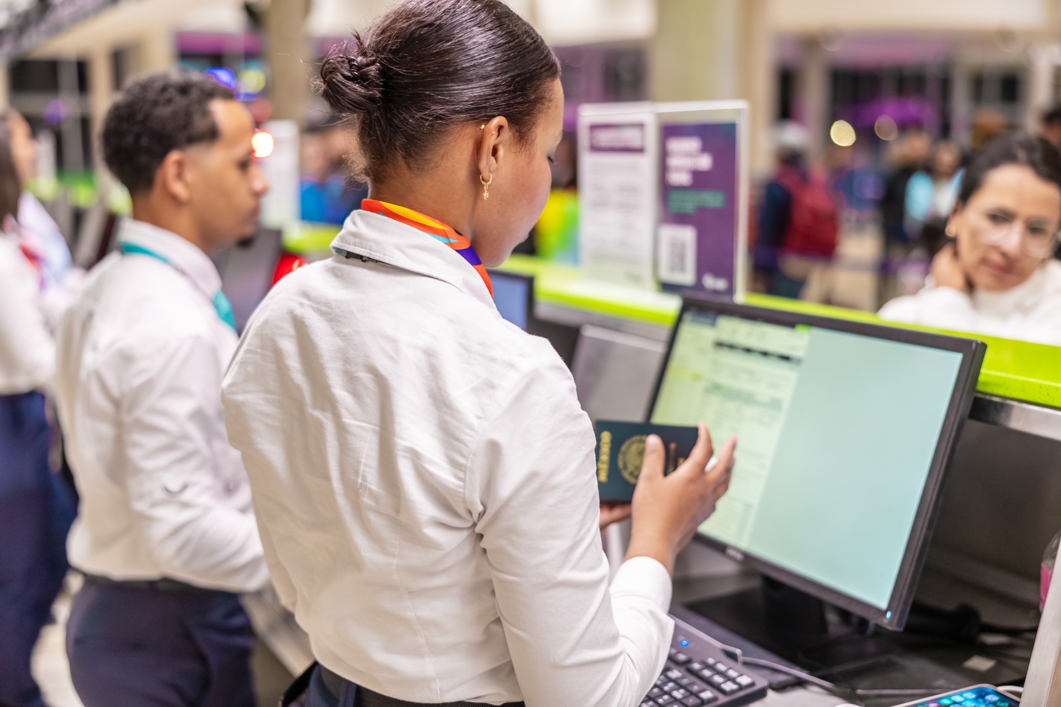 Arajet employees checking in customers at the airport
