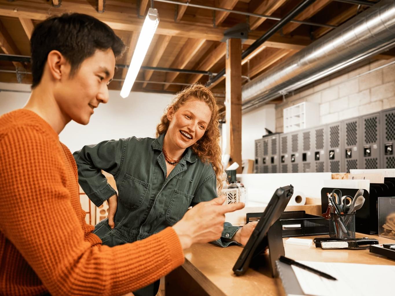 Two colleagues talk at a manufacturing warehouse