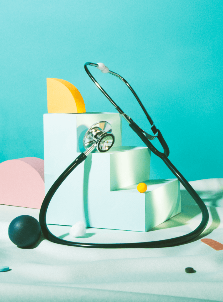 Stethoscope surrounded by various wood block shapes